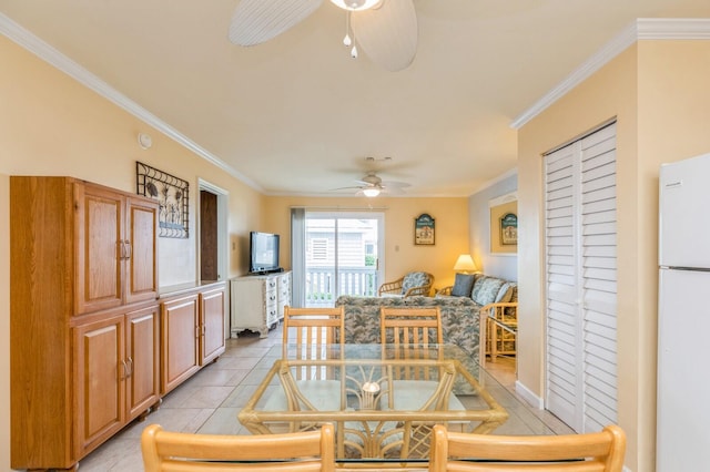 dining space featuring ceiling fan, light tile patterned floors, and crown molding