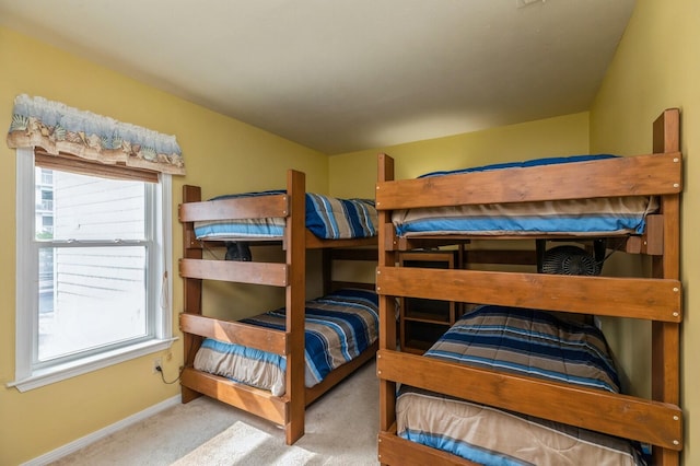 bedroom with multiple windows and carpet flooring