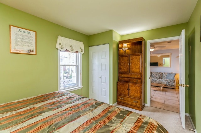 bedroom with a closet and light carpet