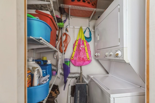 laundry room featuring stacked washer / drying machine