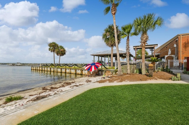 dock area featuring a water view and a yard