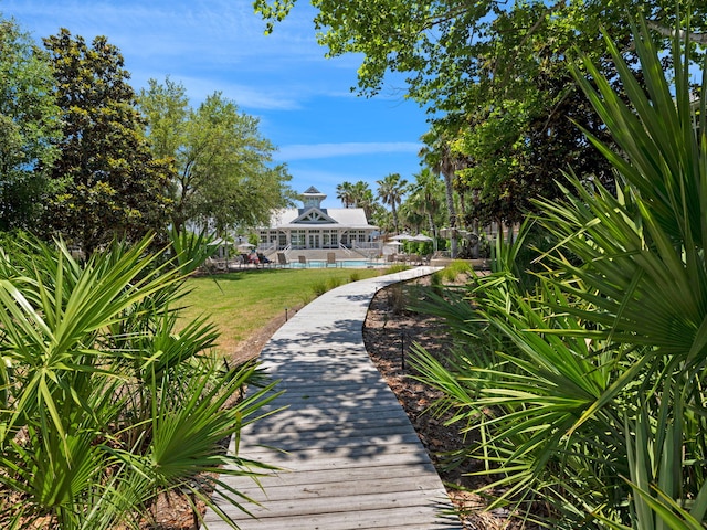 view of community with a yard and a swimming pool