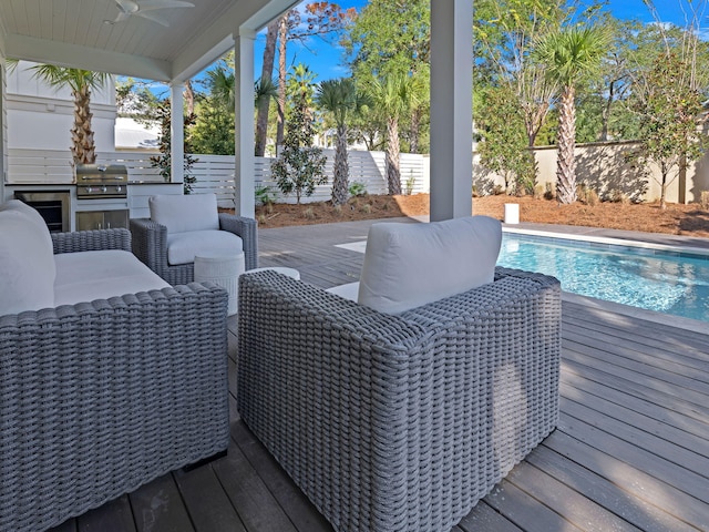 exterior space featuring ceiling fan, grilling area, and a wooden deck