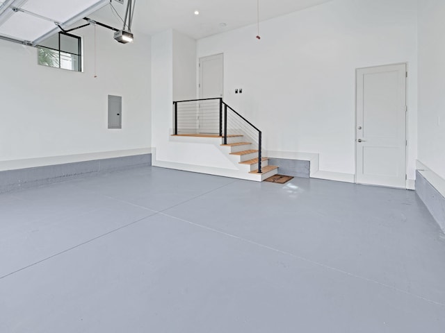 garage with electric panel and a garage door opener