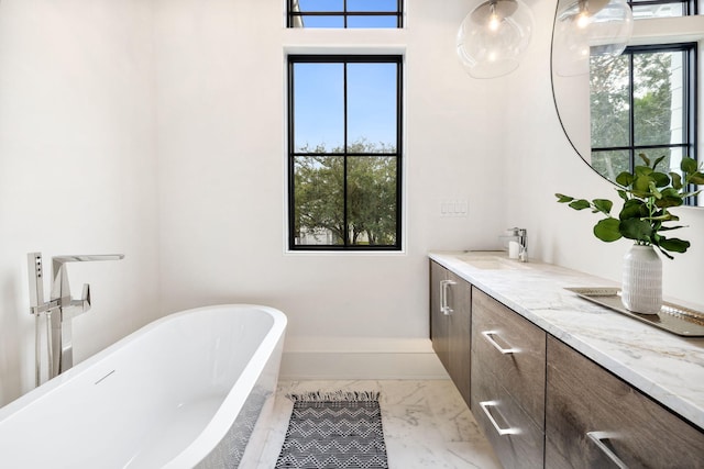 bathroom featuring vanity and a tub