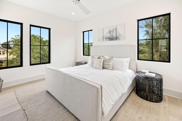 bedroom featuring light wood-type flooring and multiple windows