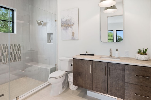 bathroom with tile patterned flooring, vanity, walk in shower, and toilet