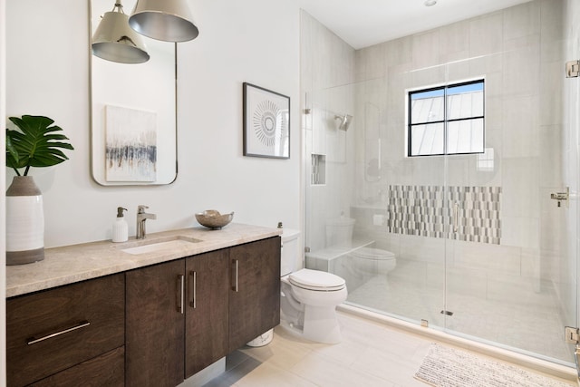 bathroom featuring vanity, tile patterned flooring, toilet, and a shower with shower door