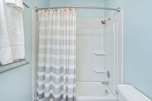 bathroom featuring toilet and shower / bath combo with shower curtain