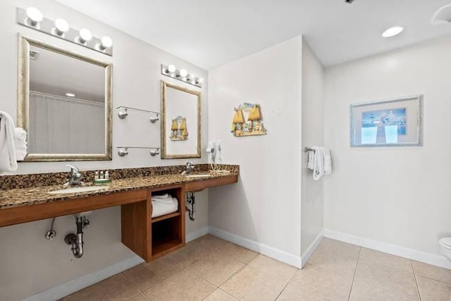 bathroom featuring tile patterned flooring, vanity, and toilet