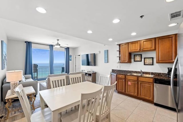 kitchen featuring light tile patterned flooring, sink, ceiling fan, and stainless steel appliances