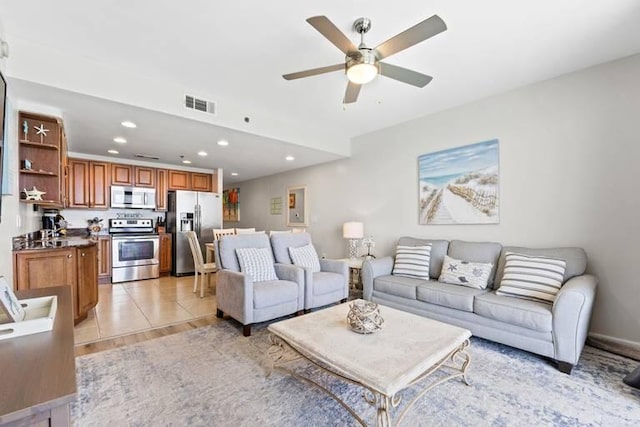 tiled living room featuring ceiling fan