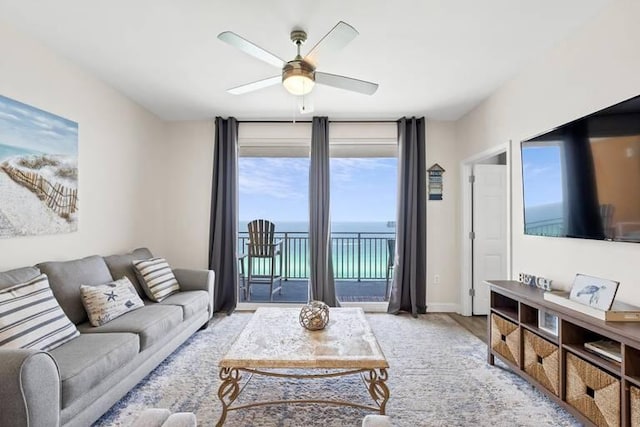 living room with light wood-type flooring and ceiling fan