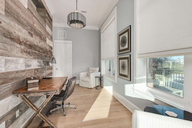 office space with crown molding, a chandelier, and light hardwood / wood-style floors