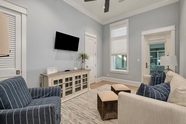 living room featuring ceiling fan, light hardwood / wood-style floors, and ornamental molding