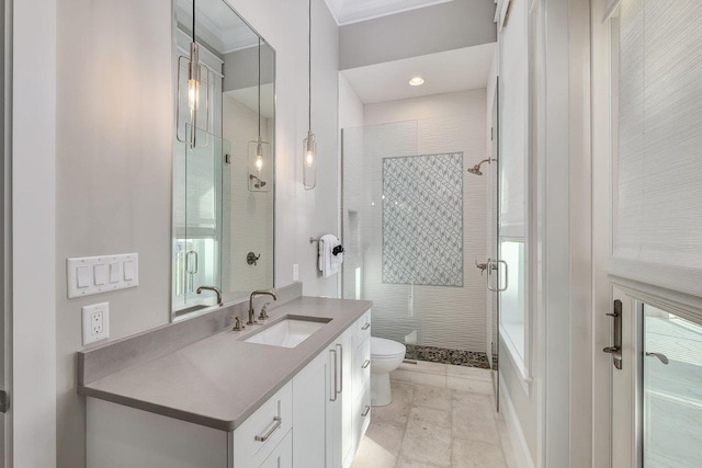 full bath featuring toilet, a stall shower, vanity, and ornamental molding