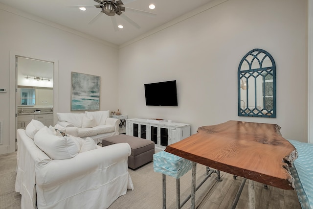 living room with ornamental molding, ceiling fan, and light hardwood / wood-style floors