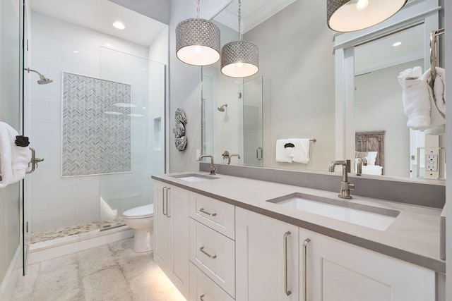 bathroom with toilet, a shower with door, crown molding, and vanity