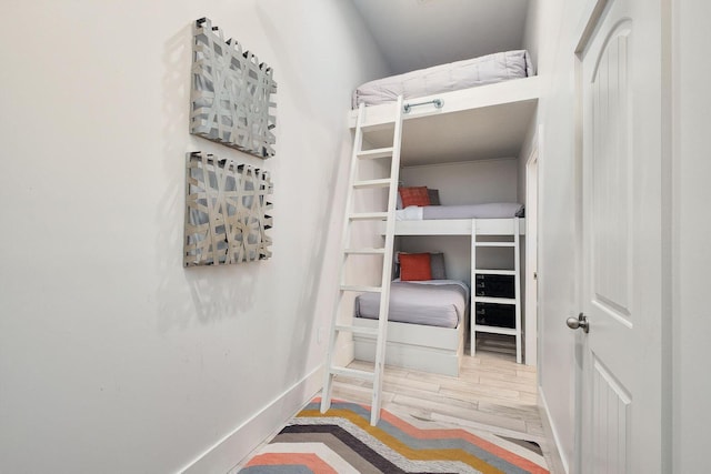 bedroom with wood finished floors and baseboards