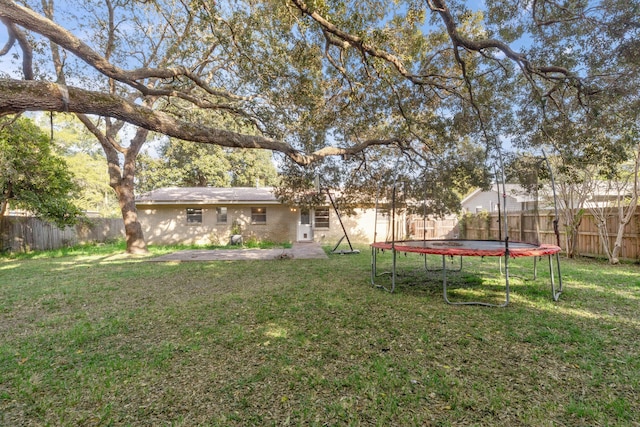 view of yard with a trampoline