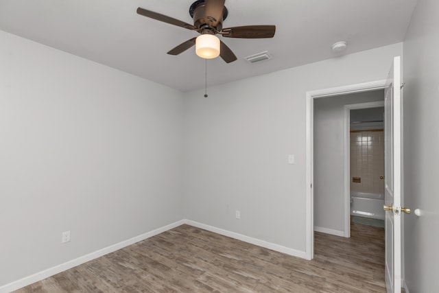 spare room featuring ceiling fan and hardwood / wood-style floors