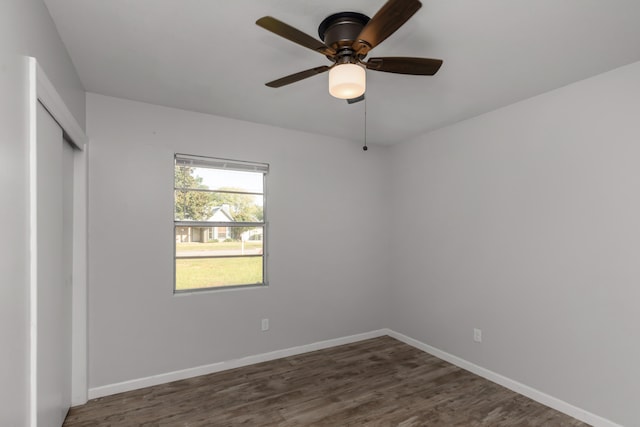 spare room with ceiling fan and dark hardwood / wood-style floors