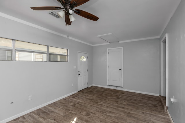 foyer entrance with ornamental molding, ceiling fan, and dark hardwood / wood-style flooring