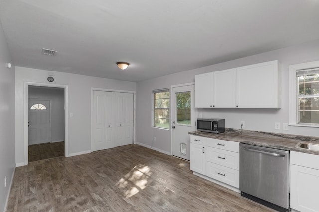 kitchen with hardwood / wood-style flooring, sink, stainless steel appliances, and white cabinets