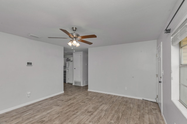 unfurnished room with ceiling fan and light wood-type flooring