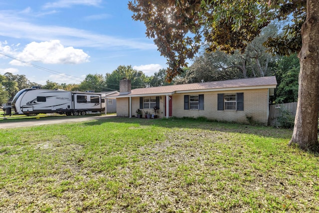 ranch-style house featuring a garage and a front yard