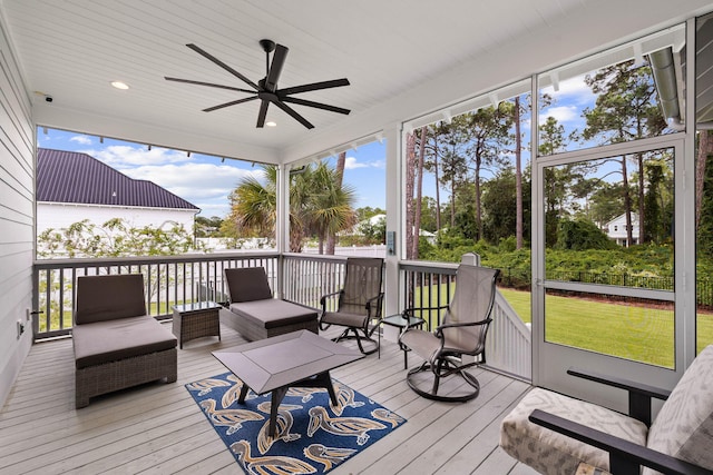 sunroom / solarium featuring ceiling fan