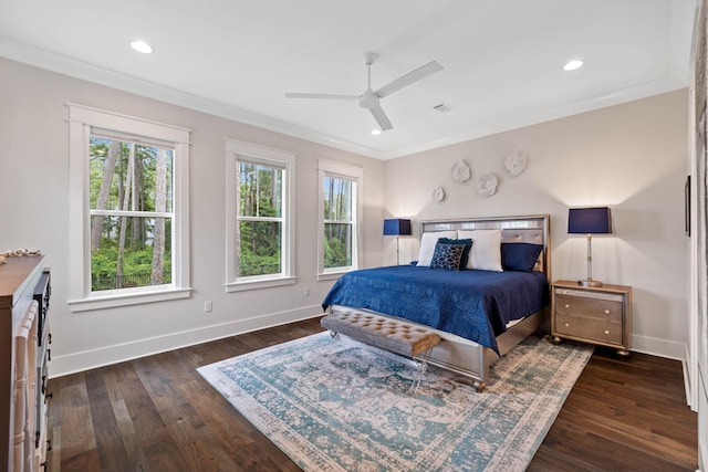 bedroom with crown molding, ceiling fan, and dark hardwood / wood-style floors