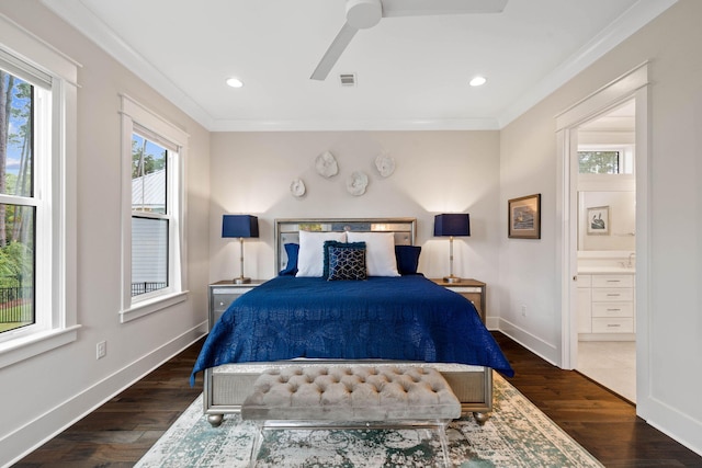 bedroom with dark wood-type flooring, ornamental molding, and connected bathroom