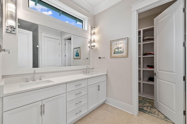 bathroom featuring tile patterned flooring, ornamental molding, and vanity