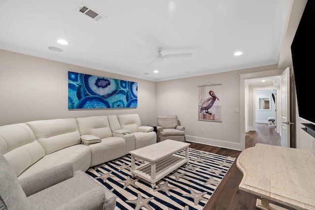 living room featuring crown molding, dark wood-type flooring, and ceiling fan