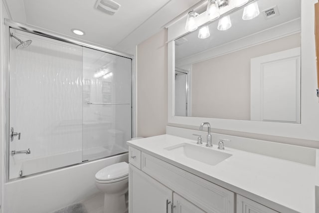 bathroom with visible vents, combined bath / shower with glass door, toilet, and vanity