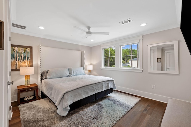 bedroom with ceiling fan, ornamental molding, and dark hardwood / wood-style floors