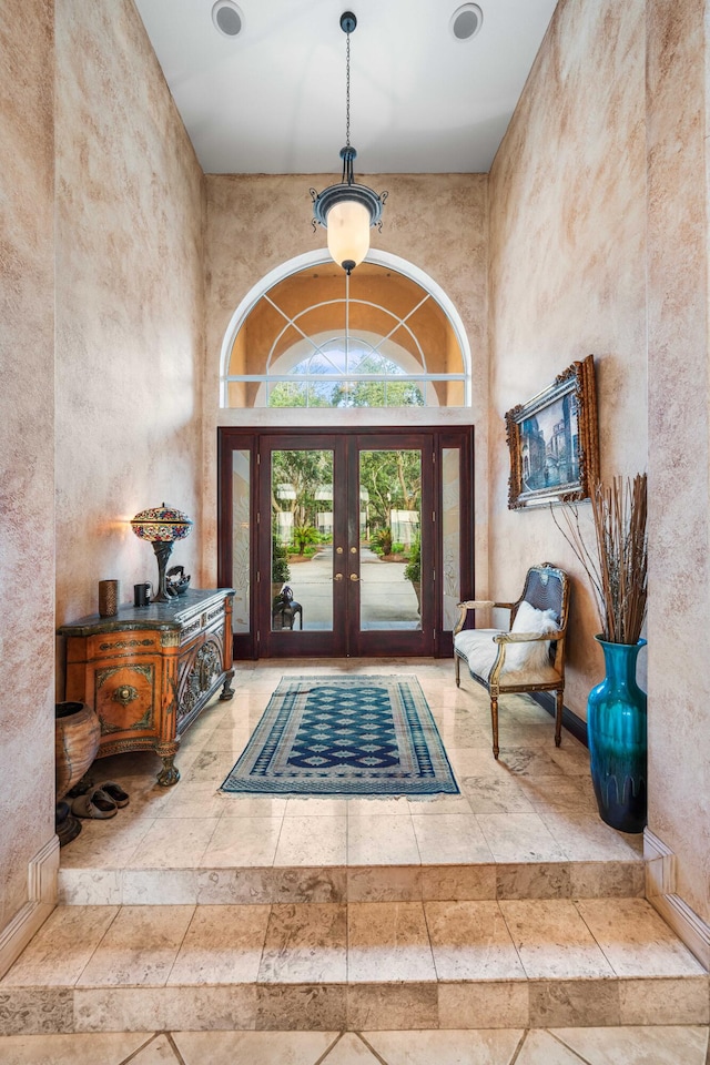 foyer entrance featuring a towering ceiling