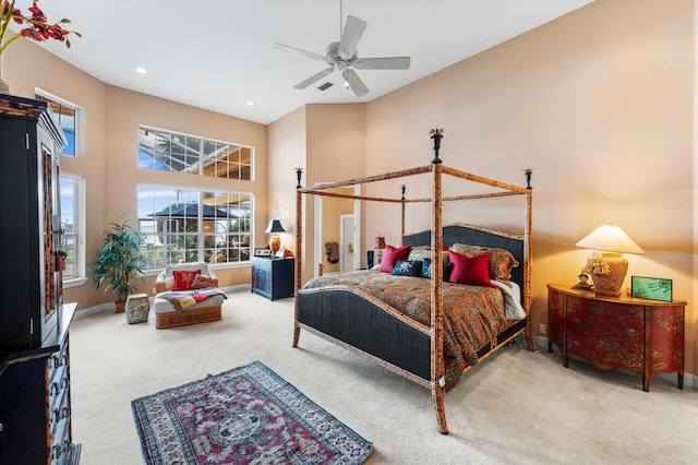 bedroom featuring carpet floors, a towering ceiling, and ceiling fan