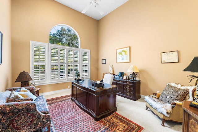 carpeted office with high vaulted ceiling and ceiling fan