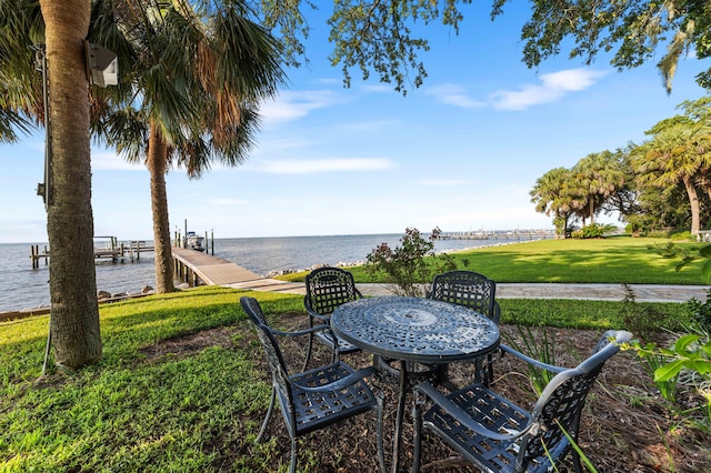 view of yard featuring a dock and a water view