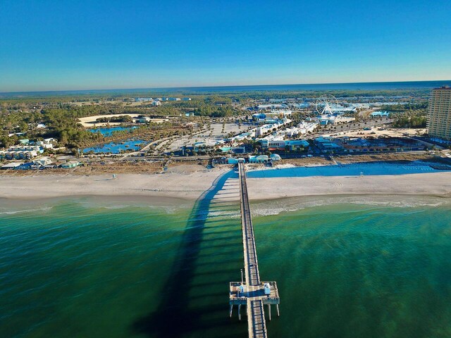 birds eye view of property featuring a water view and a beach view