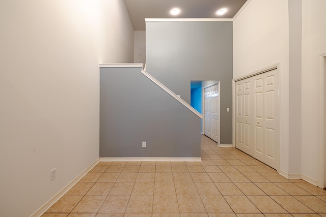 tiled entryway with a towering ceiling