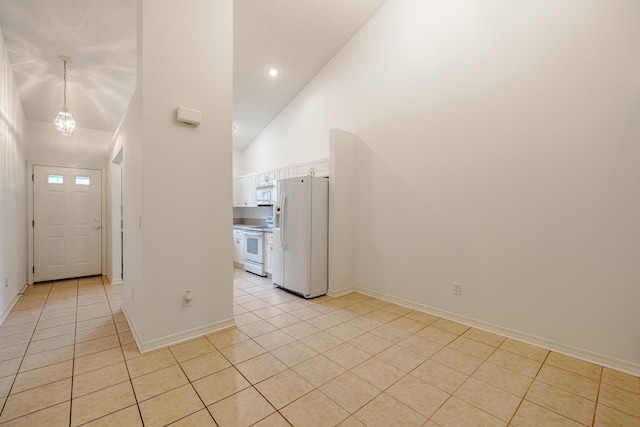 tiled entrance foyer with high vaulted ceiling