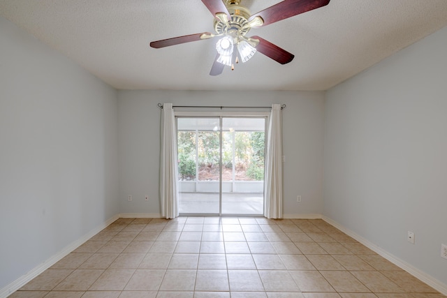 tiled spare room featuring a textured ceiling and ceiling fan