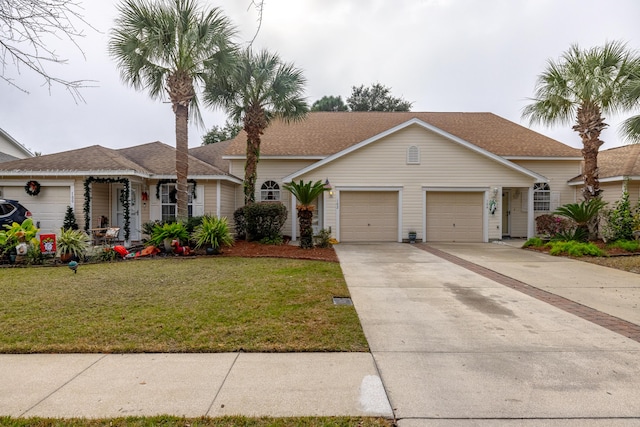 ranch-style home with a garage and a front lawn