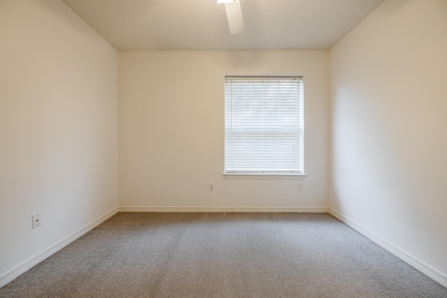 carpeted empty room featuring ceiling fan