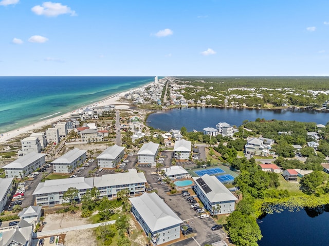 drone / aerial view with a beach view and a water view