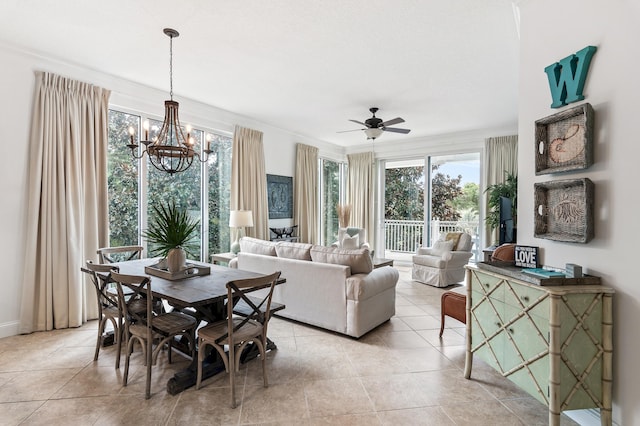 tiled dining space featuring ceiling fan with notable chandelier