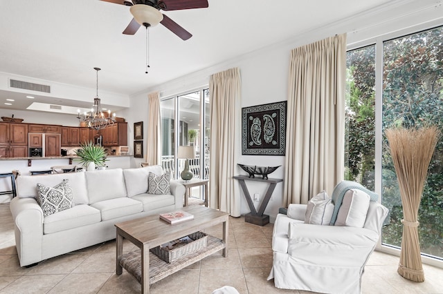 tiled living room with crown molding and ceiling fan with notable chandelier